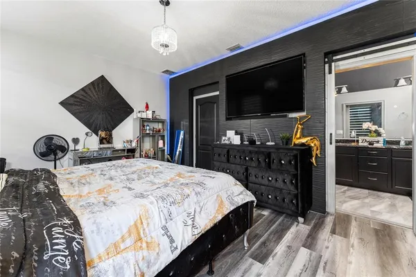 a bedroom with a bed and a flat screen tv