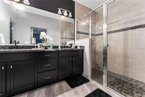 a bathroom with a double vanity sink and mirror