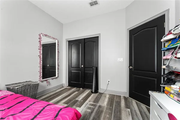 a bedroom with two bed and a flat tv screen on dresser