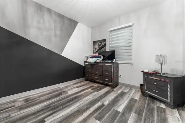 a bedroom with a bed and a dresser