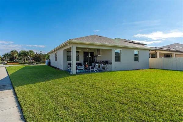 a view of a house with a backyard porch and sitting area