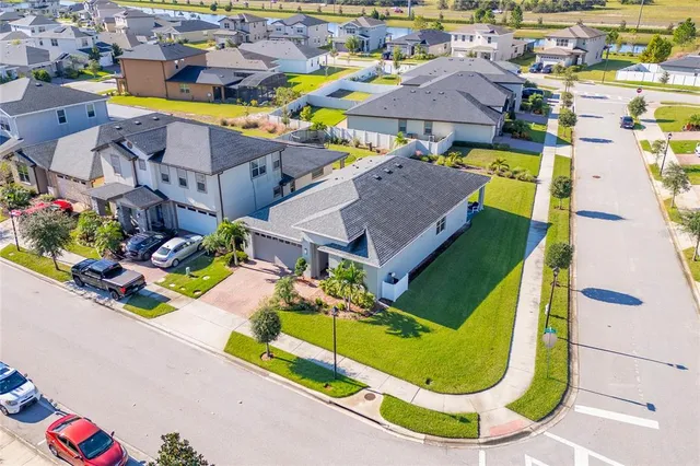 an aerial view of residential houses with outdoor space and swimming pool