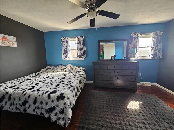 a bedroom with a bed and a window in it