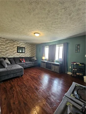 a kitchen with stainless steel appliances kitchen island granite countertop a stove a sink and a refrigerator