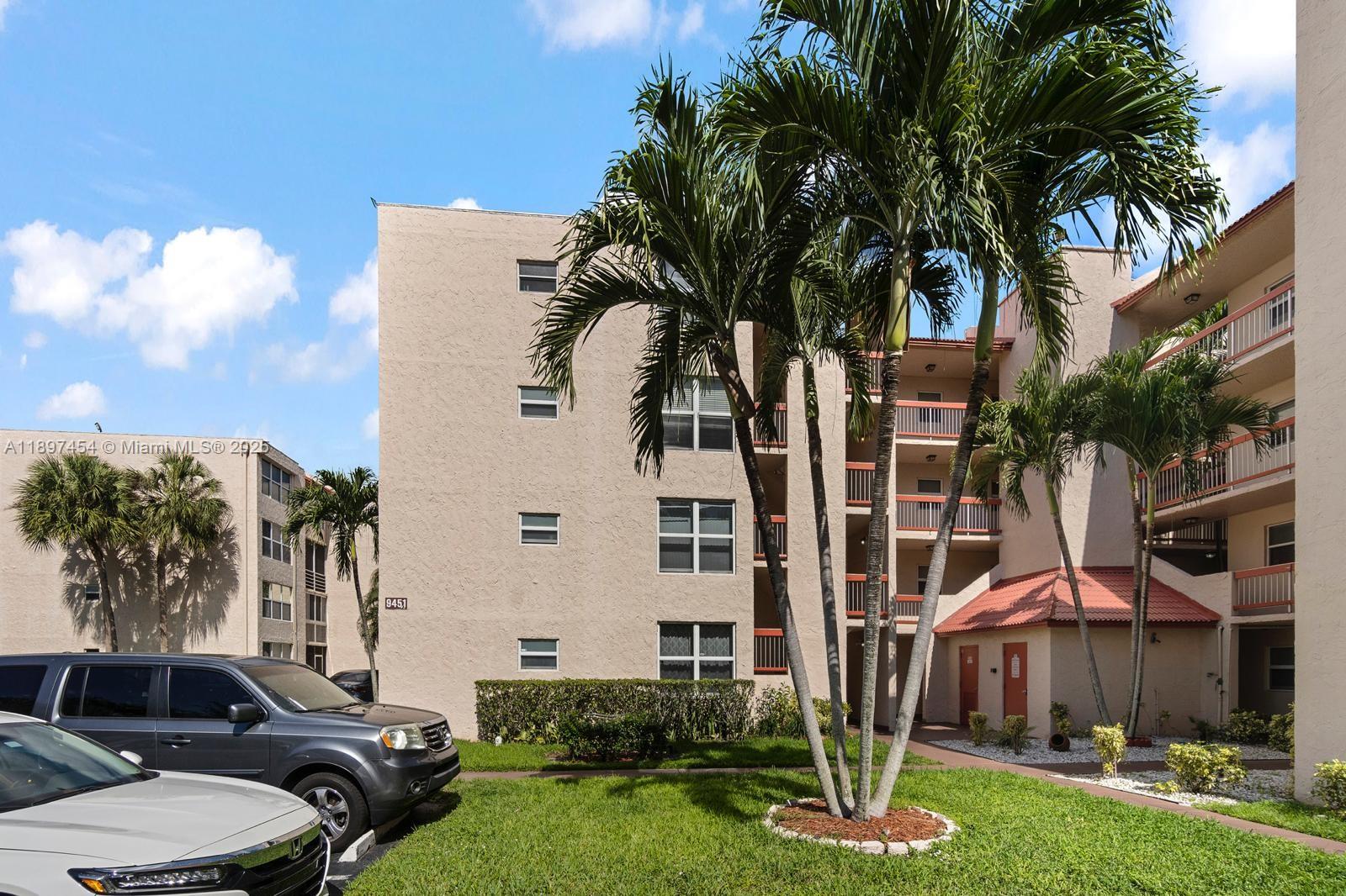 9451 Evergreen Place, Unit 303 Davie, FL 33324 - Photo 1 of 23 a front view of a building with garden