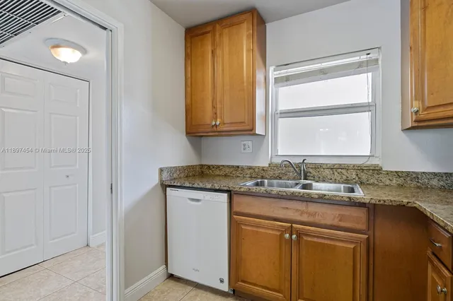 an empty room with a cabinet and mirrors