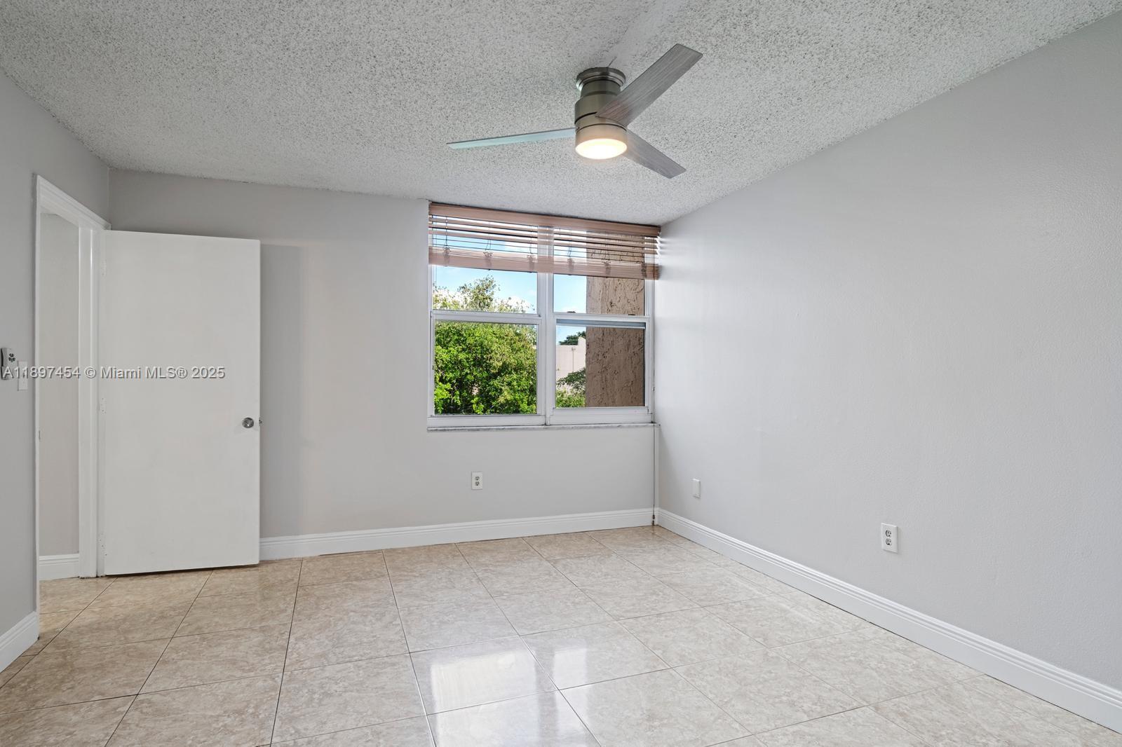 9451 Evergreen Place, Unit 303 Davie, FL 33324 - Photo 20 of 23 an empty room with a window