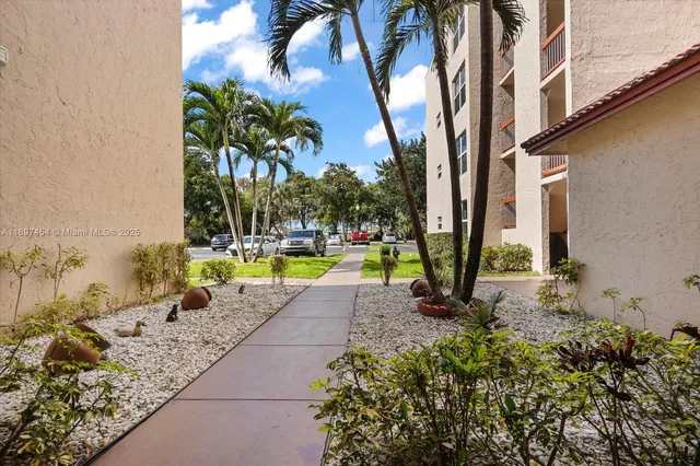 a view of a backyard with swimming pool