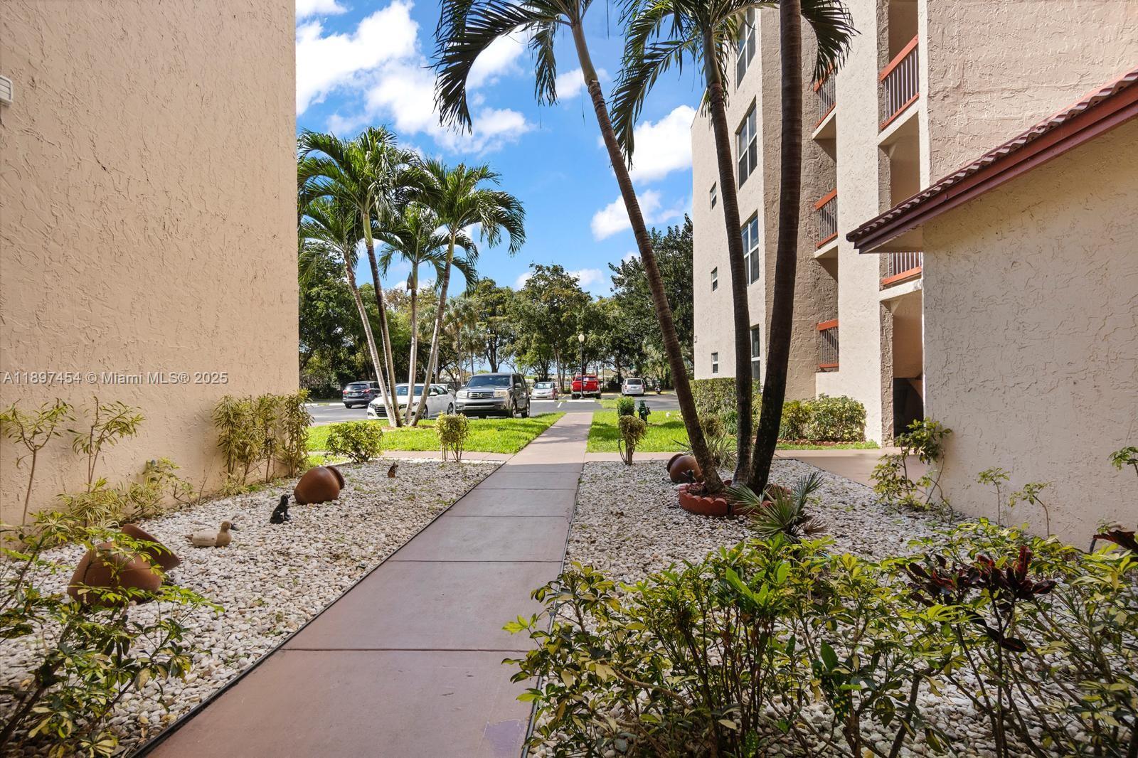 9451 Evergreen Place, Unit 303 Davie, FL 33324 - Photo 2 of 23 a view of a backyard with swimming pool