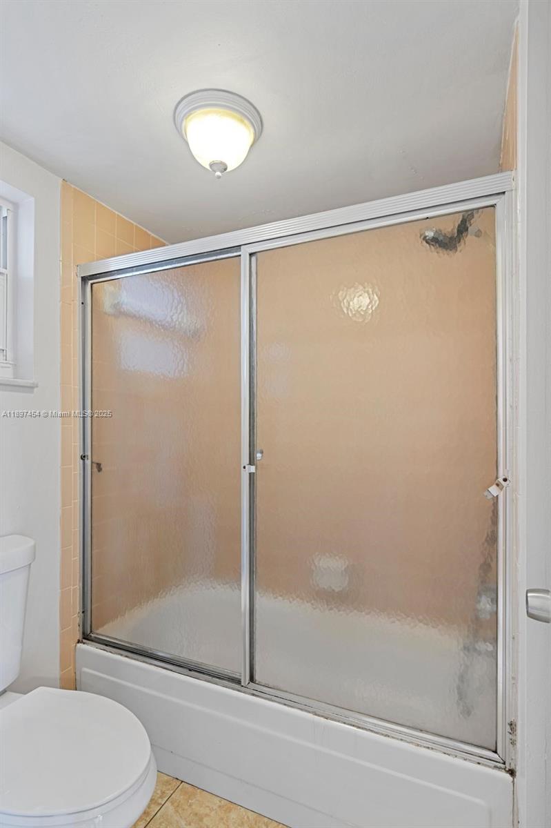 9451 Evergreen Place, Unit 303 Davie, FL 33324 - Photo 22 of 23 a bathroom with a shower and a toilet