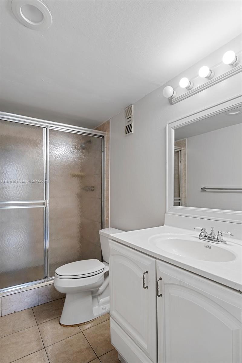 9451 Evergreen Place, Unit 303 Davie, FL 33324 - Photo 23 of 23 a bathroom with a sink a toilet and shower