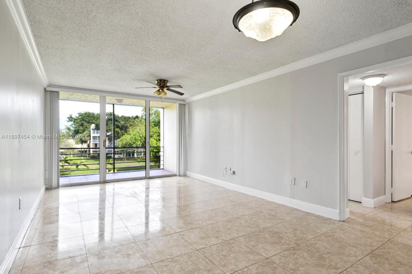 9451 Evergreen Place, Unit 303 Davie, FL 33324 - Photo 8 of 23 a view of an empty room with a sliding door