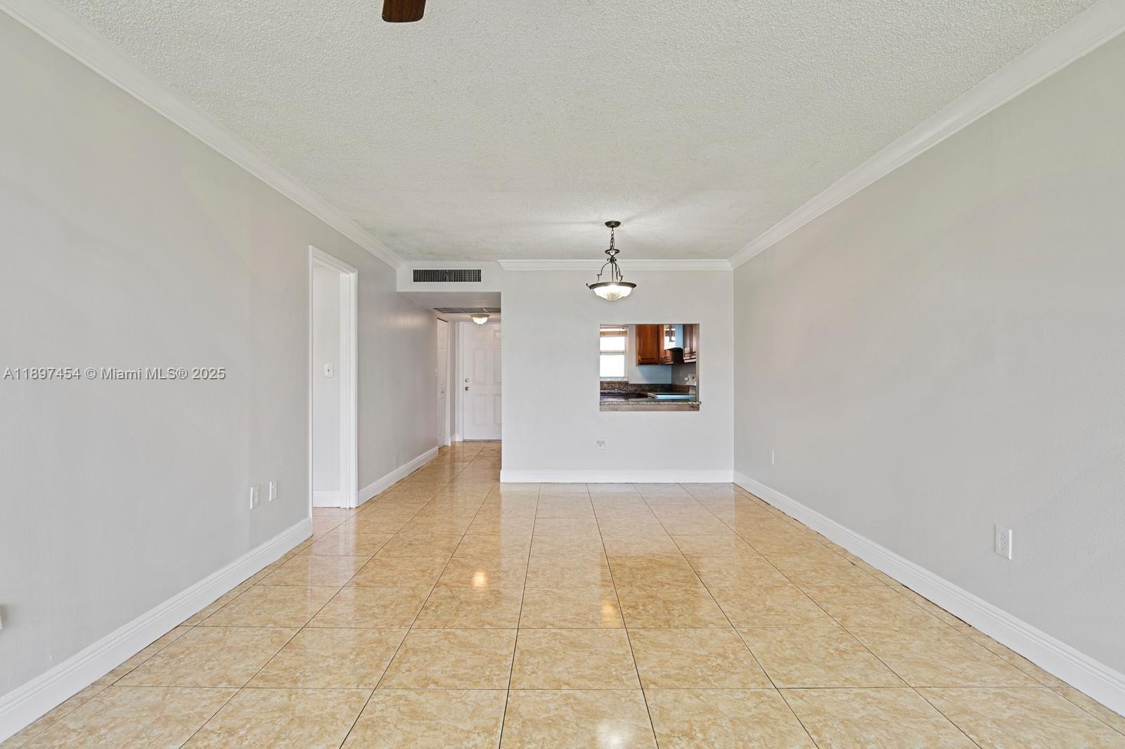 9451 Evergreen Place, Unit 303 Davie, FL 33324 - Photo 9 of 23 a view of a kitchen with a sink and a refrigerator