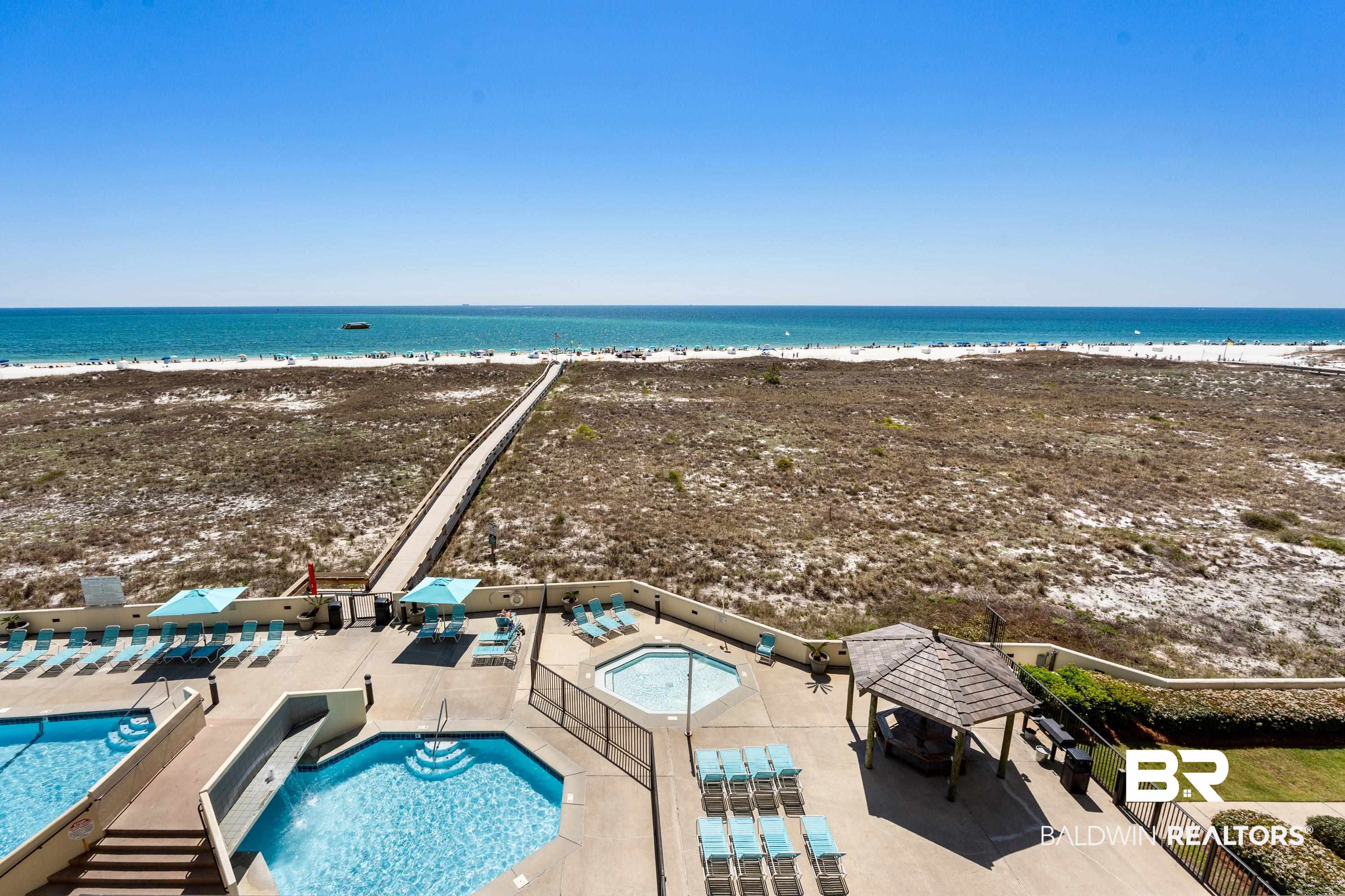 26802 Perdido Beach Boulevard, Unit 406 Orange Beach, AL 36561 - Photo 20 of 37 Community pool featuring view of water and beach, and a patio