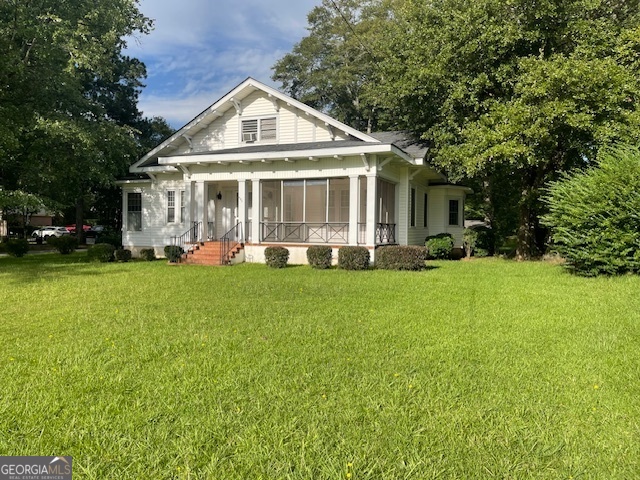 503 North Church Street Thomaston, GA 30286 - Photo 2 of 45 a front view of a house with a yard table and chairs