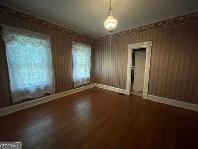 503 North Church Street Thomaston, GA 30286 - Photo 25 of 45 an empty room with wooden floor and windows with curtains
