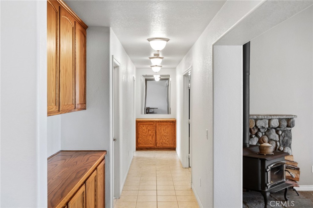 11025 El Esteban Road Phelan, CA 92371 - Photo 25 of 54 a view of a hallway with wooden floor and a bathroom