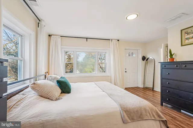 a bedroom with a large bed and a window