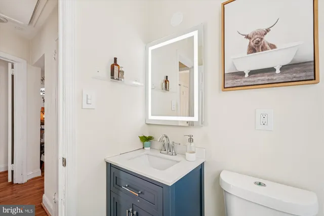 a bathroom with a toilet sink and mirror