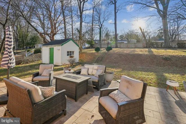 a view of a patio with couches chairs and a fire pit