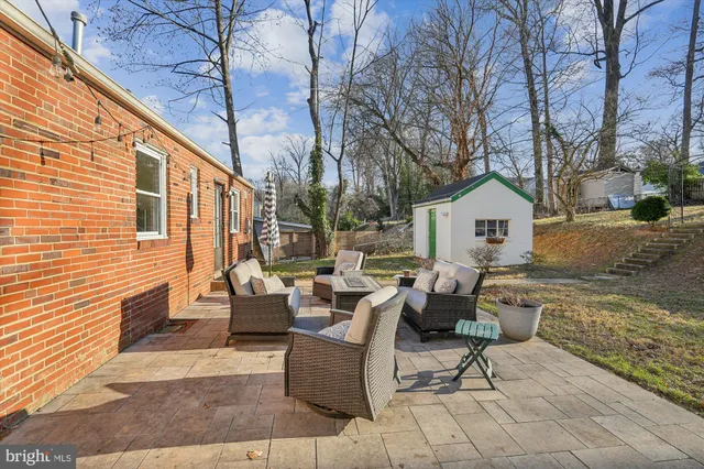 a view of backyard with seating space and trees