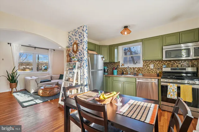 a kitchen that has a table and chairs in it