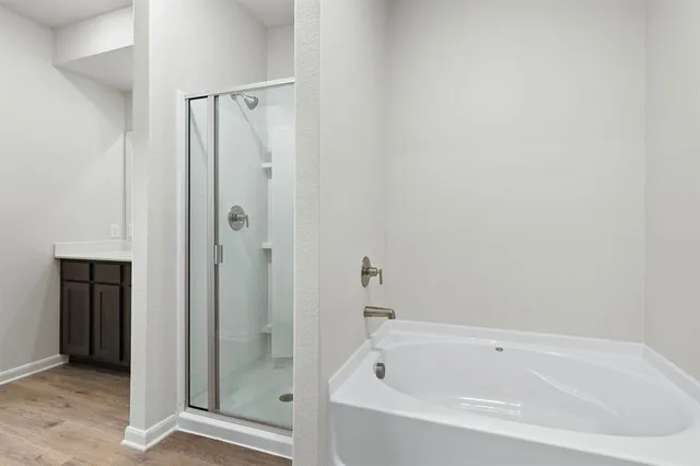 a white bath tub sitting next to a shower