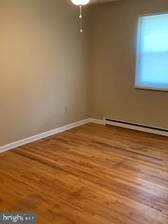 102 Bunker Hill Road New Cumberland, PA 17070 - Photo 9 of 23 a view of an empty room with wooden floor and a window