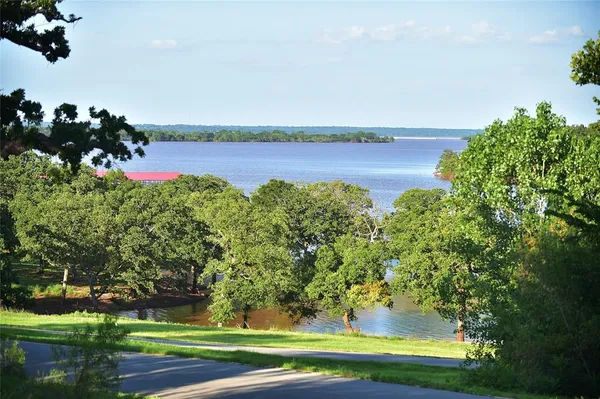 a view of a lake in middle of forest