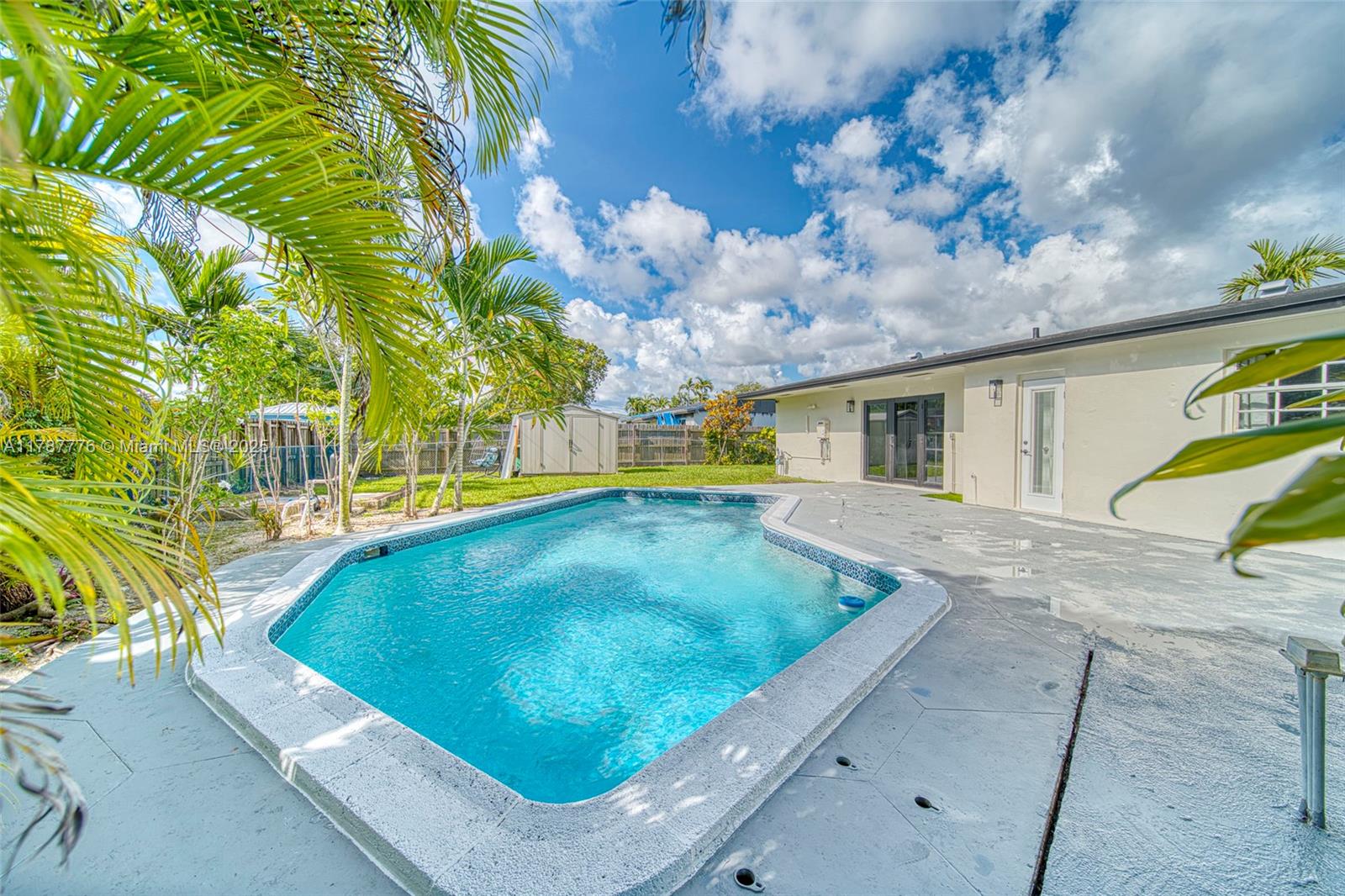 19217 Southwest 92nd Road Cutler Bay, FL 33157 - Photo 29 of 35 a view of a swimming pool with a yard