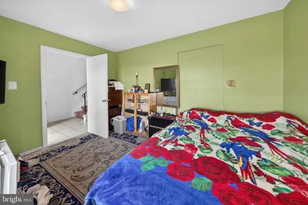 a bedroom with a bed and a dresser