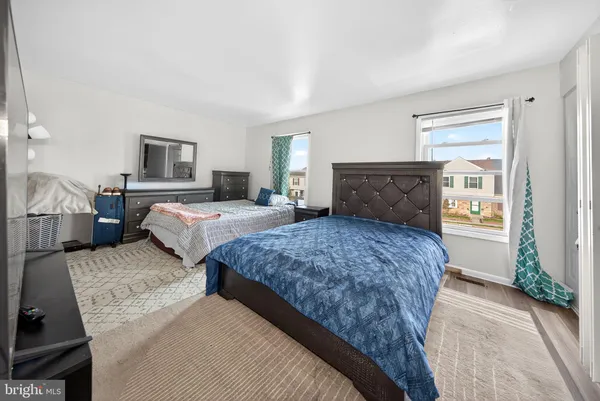 a bedroom with two beds and a window