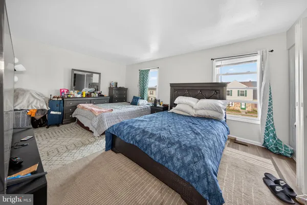 a bedroom with bed and a couch