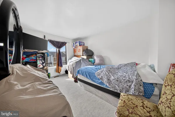 a bedroom with bed and a flat tv screen