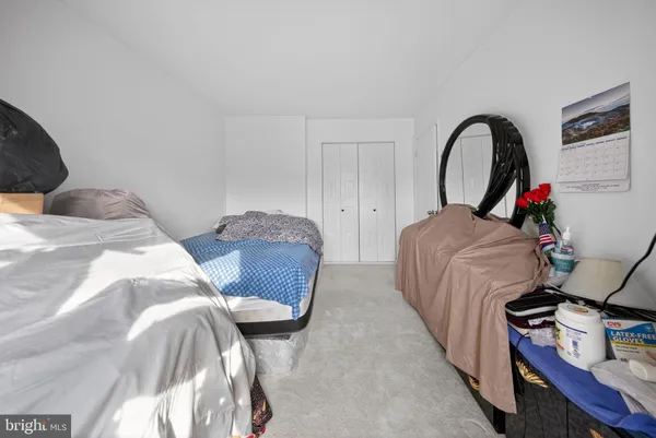 a bedroom with bed and a window