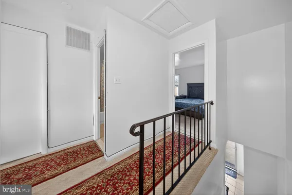 a view of a hallway with wooden floor and stairs