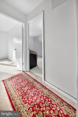 a bedroom with a bed and a rug
