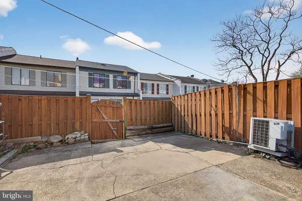 a view of a house with wooden fence