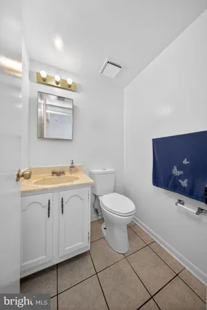 a bathroom with a sink a toilet and mirror