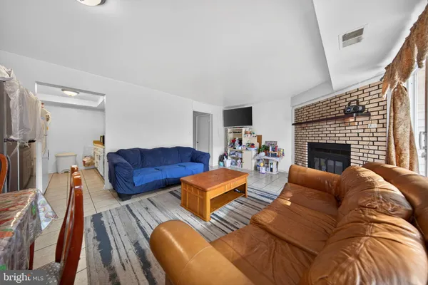 a living room with furniture fireplace and a flat screen tv
