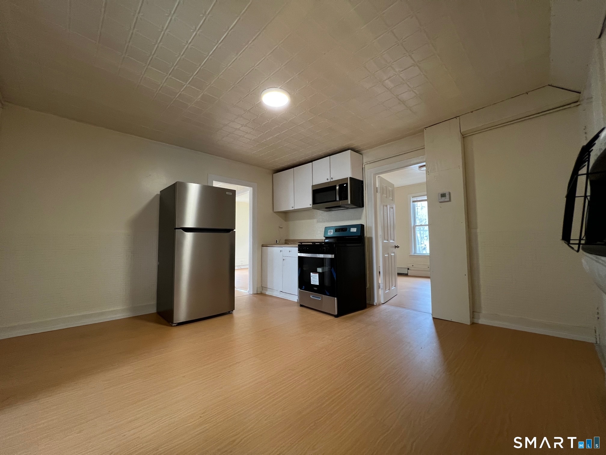 62 North Leonard Street Waterbury, CT 06708 - Photo 3 of 13 a kitchen with stainless steel appliances a refrigerator and a stove