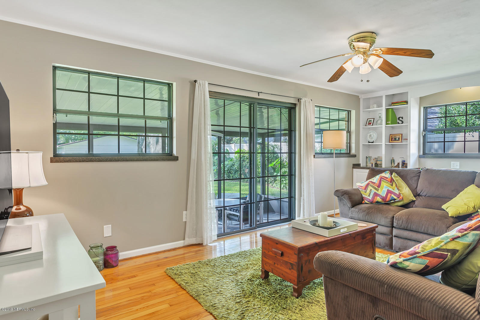 8702 Sanchez Road Jacksonville, FL 32217 - Photo 13 of 34 a living room with furniture and large windows