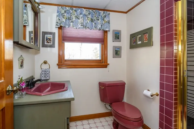 a bathroom with a toilet sink and mirror