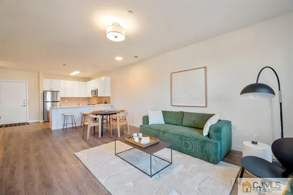 a view of a a dining room with furniture and wooden floor