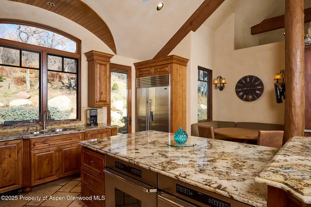 a bathroom with a granite countertop sink and a large mirror