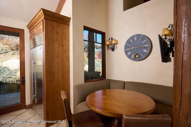 a view of a dining room with furniture and a large window