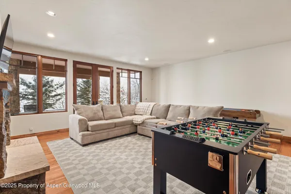 a living room with furniture and a floor to ceiling window