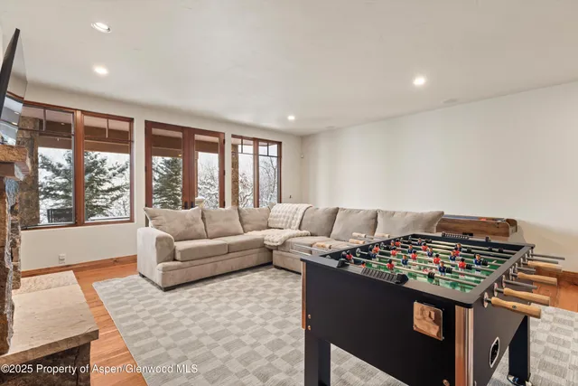 a living room with furniture and a floor to ceiling window