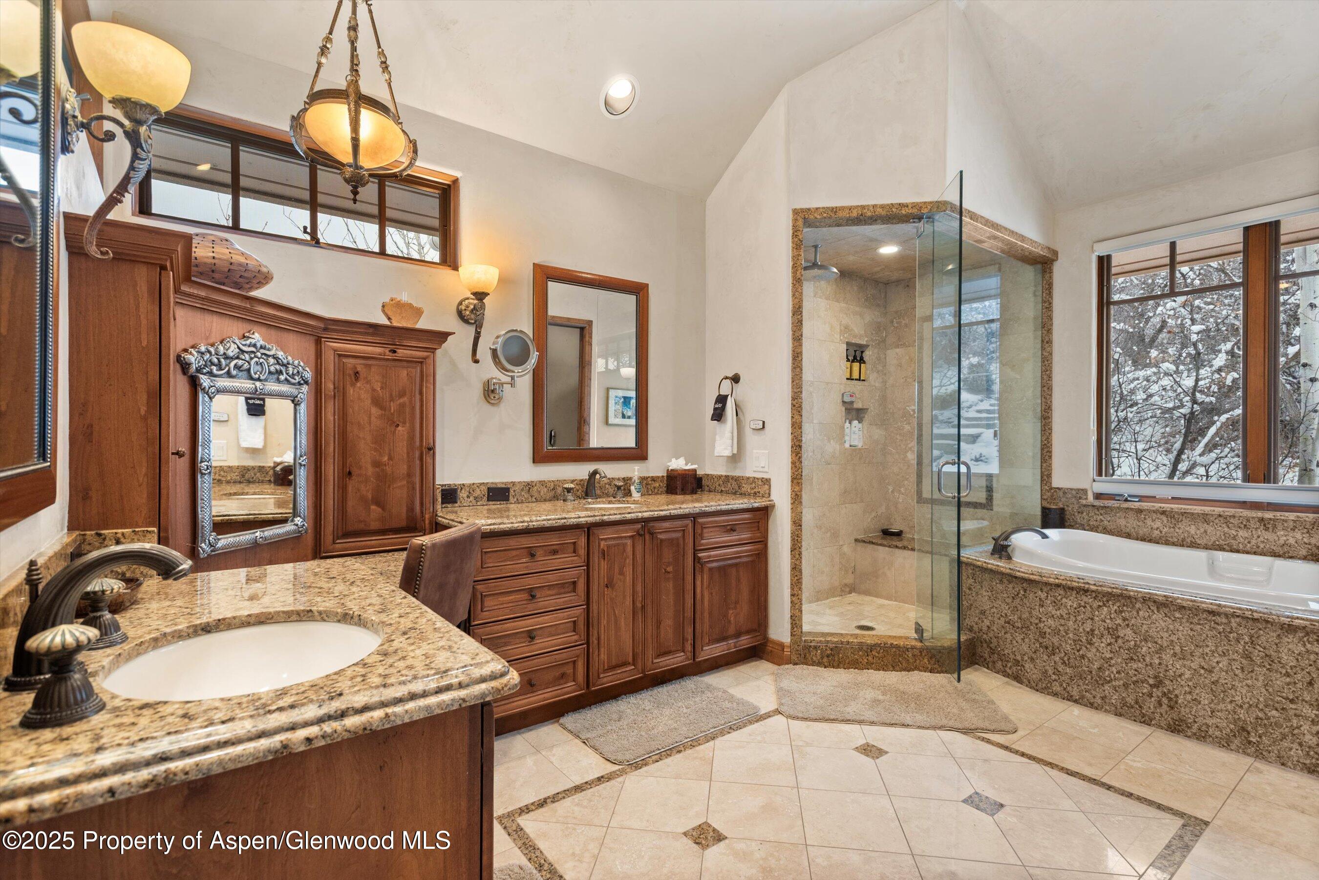 121 Oak Ridge Road Snowmass Village, CO 81615 - Photo 17 of 28 a spacious bathroom with a sink a large mirror and a bathtub