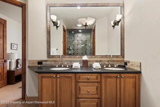 a bathroom with a double vanity sink and a mirror